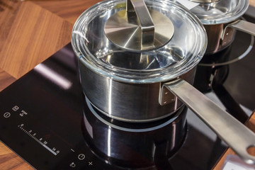 Metal Pot on induction hob in modern kitchen. modern kitchen pot cooking induction electrical stove hob concept
