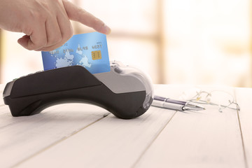 Cashier hand over EDC machine or credit card terminal to made an online payment.