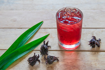 Iced Roselle juice on wooden  background, herbal organic tea for good healthy and refreshment. 
