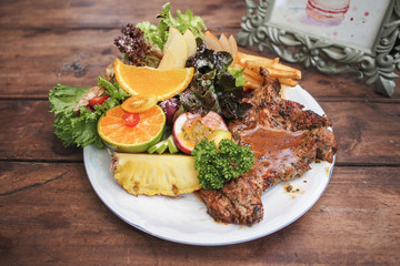 Pork chop steak with fruit salad