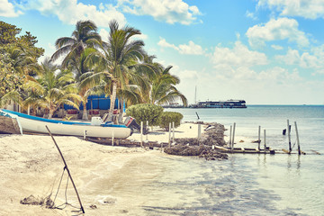 Peaceful bay with fishing boat on caribbean island / Very calm bay with turtle farm on so called island of 