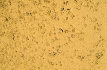 Texture of the yellow paint on the concrete