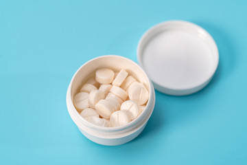 White tablets in a plastic container