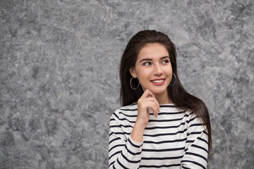 Beautiful young girl holing her finger up inferring that she has had a good or new idea