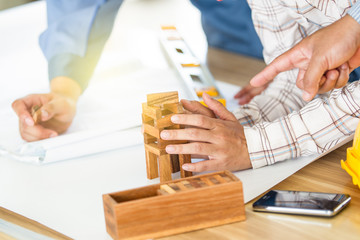 Men build a wood brick for model close up.