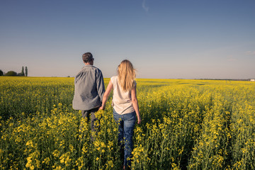 Romantic couple in a field of yellow flowers