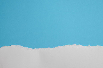 Obraz premium white torn paper with blue background, ready for design