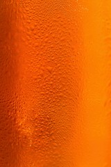 Beer. Beautiful detail of beaten glass of beer with foam. Abstract colorful background.