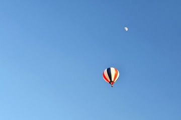 Colorful hot air balloon flying at sunset. Natural colorful background with sky.