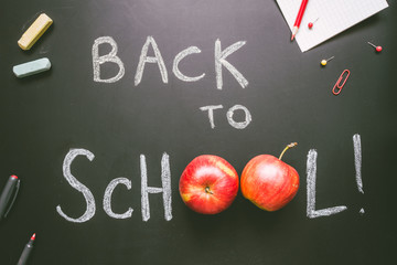 Back to school. School supplies on the chalkboard background, education concept
