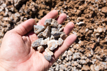 Building crushed stone with sand in hand