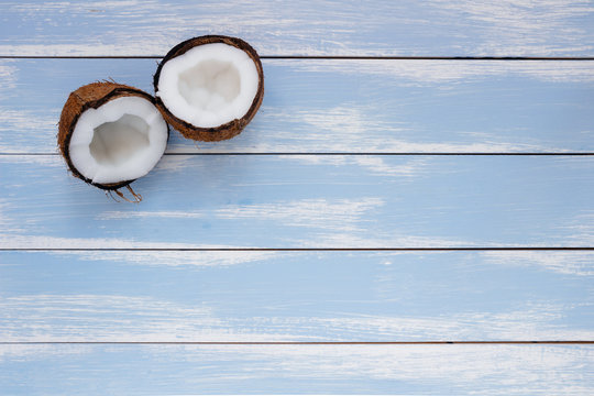 Ripe coconut on the wooden blue table, top view, with copy space