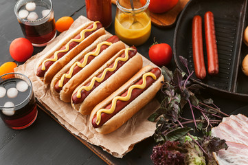 American hot dog with ingredients on a dark wooden background