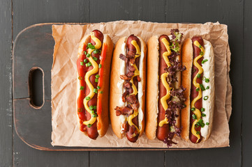 Barbecue Grilled Hot Dogs with  yellow American mustard, On a dark wooden background