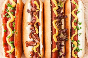 Barbecue Grilled Hot Dogs with  yellow American mustard, On a dark wooden background