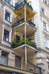 Fototapeta na wymiar three balconies on a tenement building in downtown