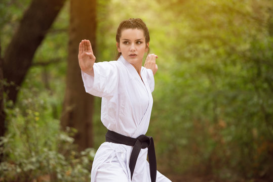 Woman In White Training Karate at Park