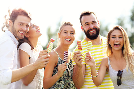 Group of friends eating ice-cream outdoors