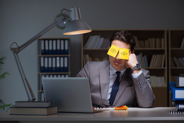 Businessman staying late to sort out priorities