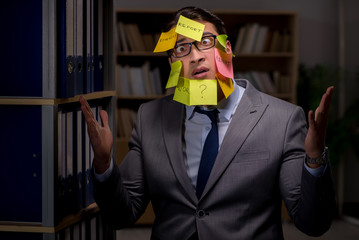 Businessman struggling with conflicting priorities during long h