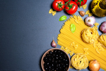 Top view: pasta or italian spaghetti on black stone slate background