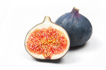 Macro: fresh ripe figs on white wooden table