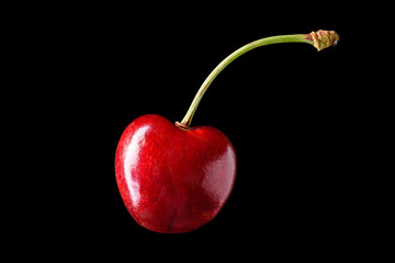 Isolated sweet merry cherry over black background