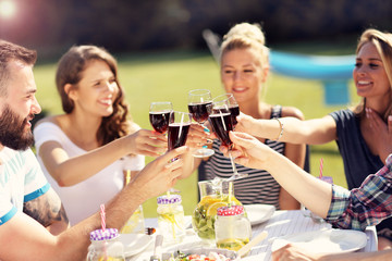 Friends having barbecue party in backyard