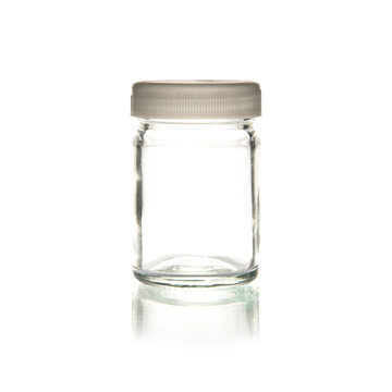 Glass bottle with lid isolated on white background .