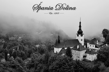 Summer in Slovakia. Old mining village. Historic church in Spania dolina. Black and white country in fog after the storm. - obrazy, fototapety, plakaty