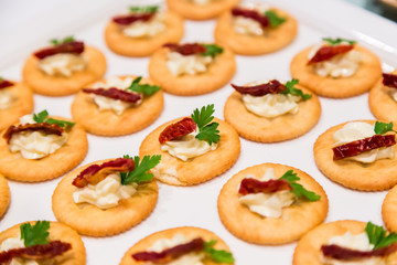 Cheese canape with chili on crackers