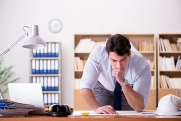 Engineer supervisor working on drawings in the office