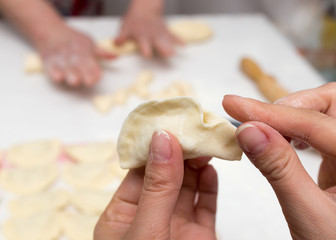 Cook cooks vareniki with potatoes
