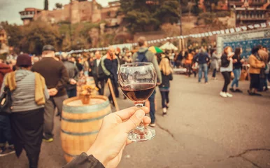 Foto op Plexiglas Wine drinkers on the city festival and crowd of people around.  © radiokafka