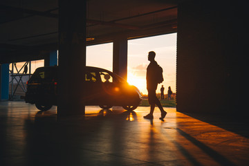 parking place with car man walks to car
