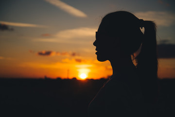 Silhouette of a woman with evening sky