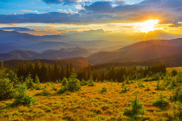 beautiful evening mountains in a mist at the sunset