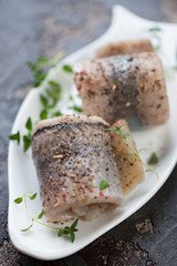 Close-up of herring fillet rolls, selective focus, shallow depth of field, studio shot