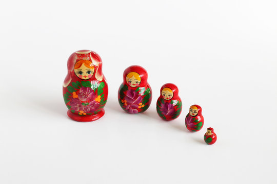 5 matryoshka russian dolls on white background, copy space
