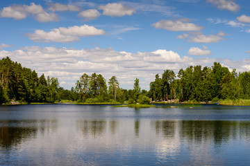 Fototapeta na wymiar Beautiful landscape with lake and clouds. Vuoksa lake - a picturesque lake in Leningradskaya oblast, Russia