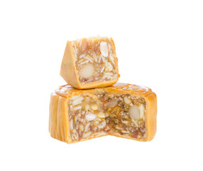 Moon cakes stuffed with five nuts; almond, walnut, white sesame, watermelon seeds, cashew nuts cut in half and small piece for bit size on stack isolated on white background (clipping path included)