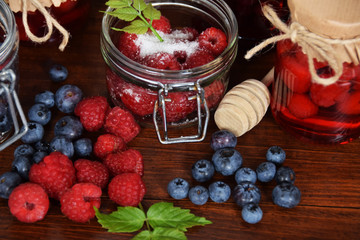 blueberries and raspberries in jars for the winter tea