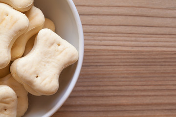 bone shaped dog cookies in a white bowl