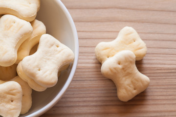 bone shaped dog cookies in a white bowl