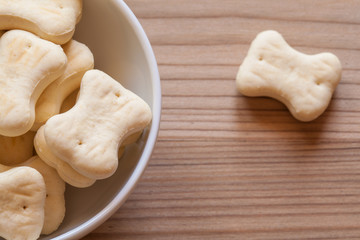 bone shaped dog cookies in a white bowl