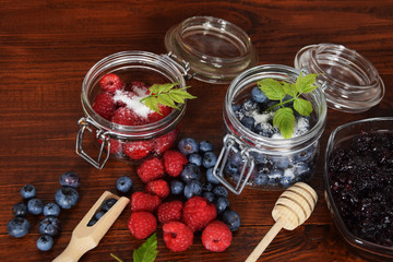 blueberries and raspberries in jars for the winter tea