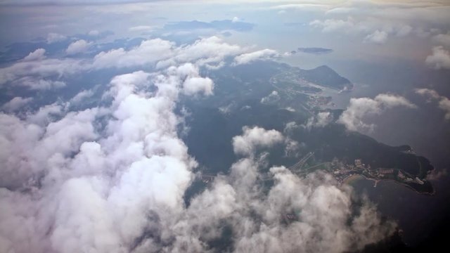 4K Aerial View Of Busan Metropolitan City From Above With Clouds. Traveling by air. Wonderful view of the sky and clouds as seen through an airplane window in South Korea.-Dan
