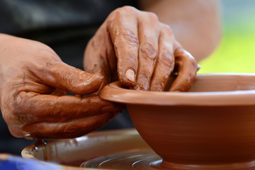 Potter making ceramic pot on the pottery wheel