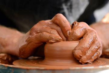 Potter making ceramic pot on the pottery wheel