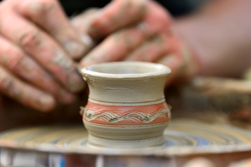 Potter making ceramic pot on the pottery wheel